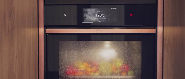 Close-up of N90 Metallic Silver oven showing Intensive Steam behind the steamed up oven door