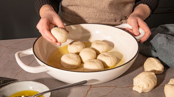 Placing the dough balls into a skillet
