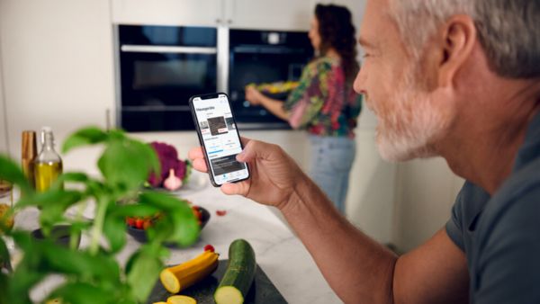Image of a person photographing their dish using a mobile device.