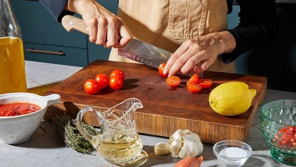 Halve cherry tomatoes on a cutting board