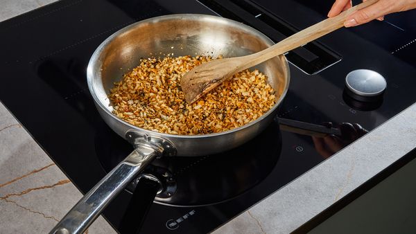 Making a crunchy topping in a frying pan 