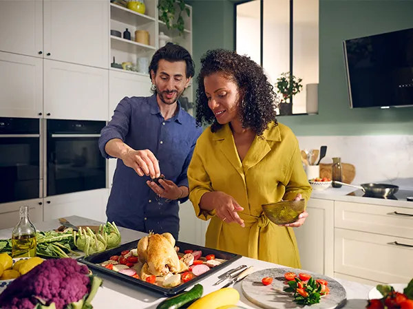 Woman standing next to an oven