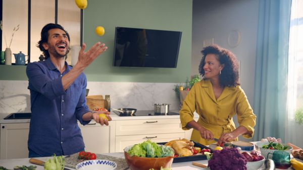 Woman holding a sauce pan in a kitchen