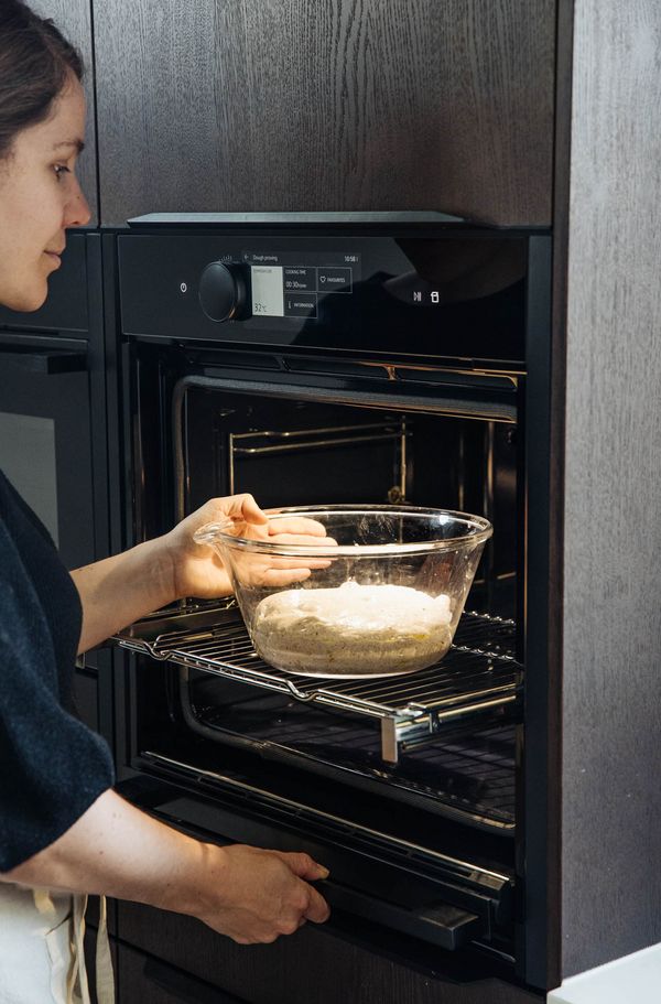 Dough mixture in mixing bowl put into the oven for rising. 