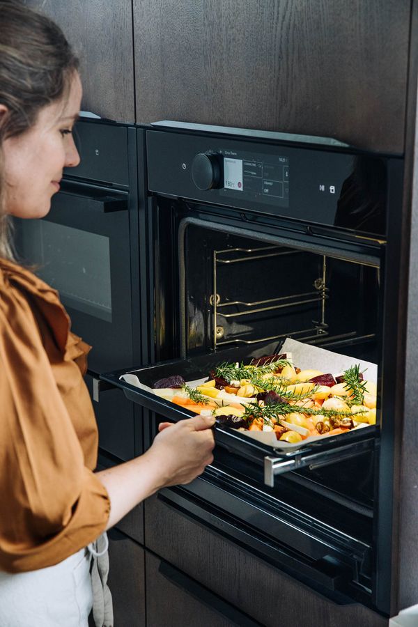 Vegetables placed on baking try and into the NEFF oven for cooking. 