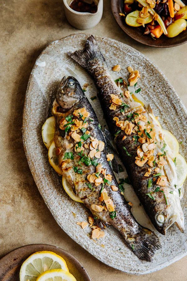 Fish served on plate with vegetables, ready to enjoy. 