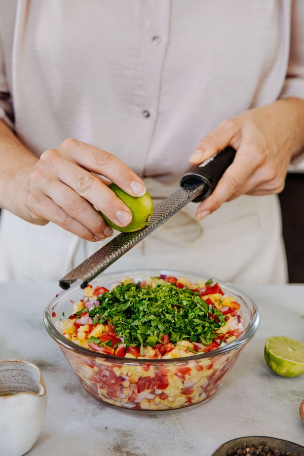 Zesting a lime into a mixing bowl.