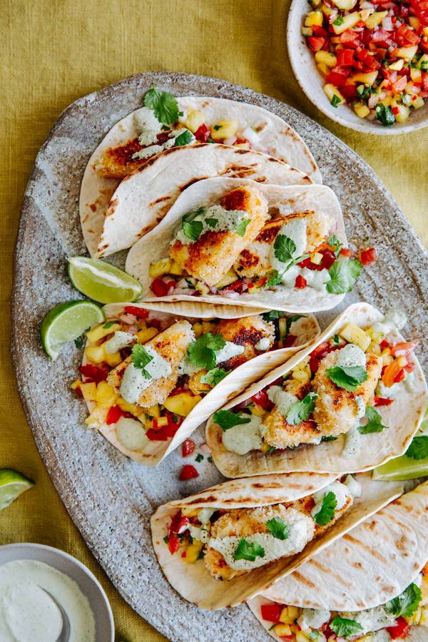 Fish Tacos presented on plate with lime wedges ready to enjoy. 