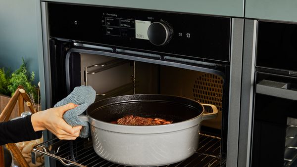 Transferring beef pot roast to the oven to roast