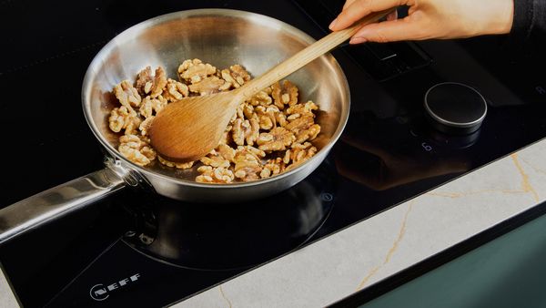 Toasting walnuts in a pan