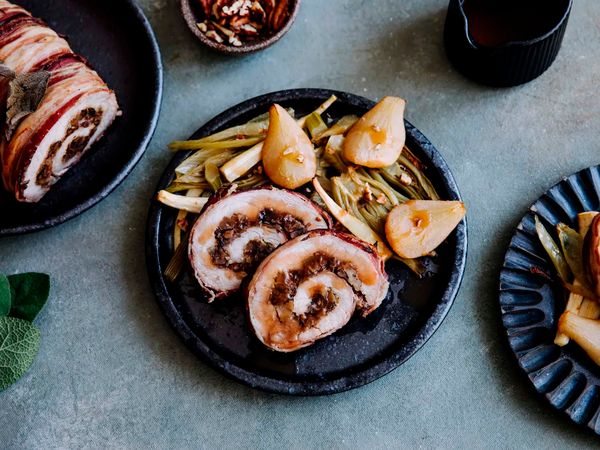 Roast pork presented on plate with pear and fennel