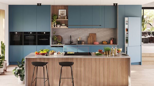  A contemporary kitchen featuring blue cabinets and elegant wooden flooring, showcasing a stylish and inviting atmosphere.  