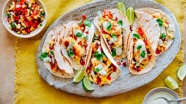 Fish tacos presented on large plate in a dining table setting