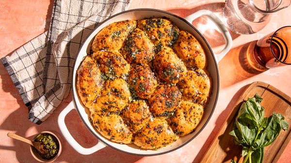 Freshly baked pull-apart basil bread served in a skillet