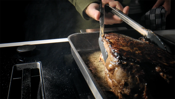 Cooking beef in dish over vegetables