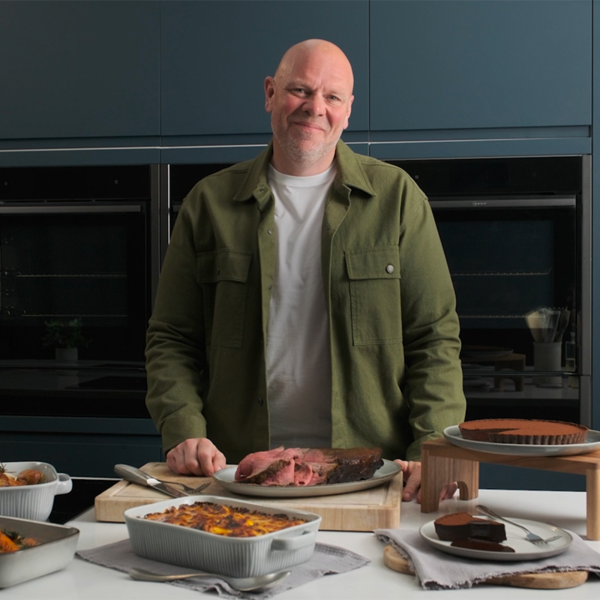 Tom Kerridge standing in NEFF kitchen with all created dishes