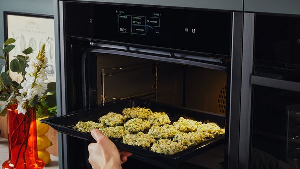 Transferring zucchini fritters to an oven