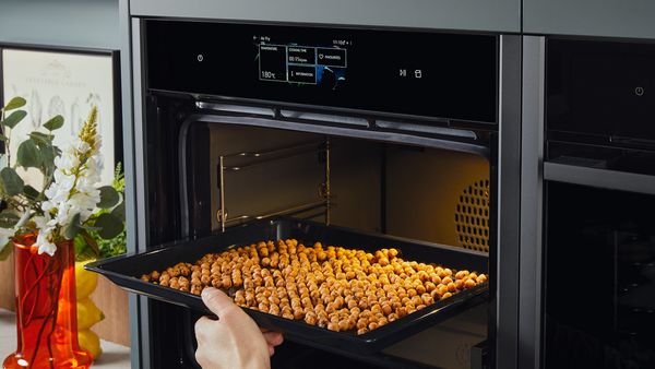 Transferring spiced chickpeas to an oven