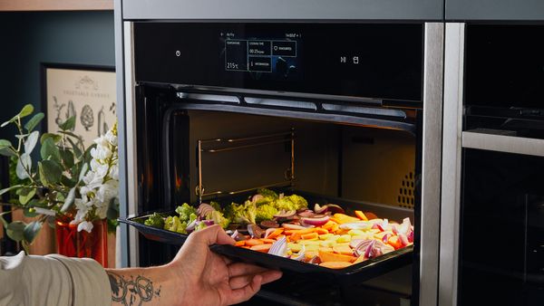 Transferring vegetables to an oven