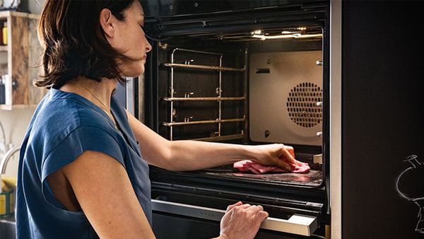 Person cleaning inside of oven