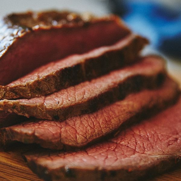 Sliced roast beef on wooden board