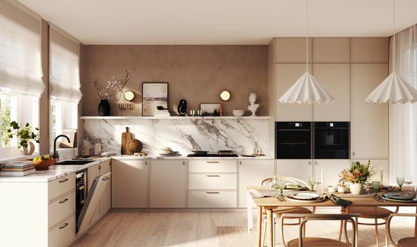 A cozy kitchen featuring a wooden table surrounded by chairs, creating a welcoming dining space.  