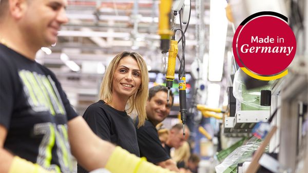 A bustling automotive factory in Germany, showcasing the kitchen appliances industry with workers and modern machinery. 