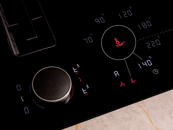 Close-up of a stove top control panel featuring a frying sensor for precise cooking temperature management.