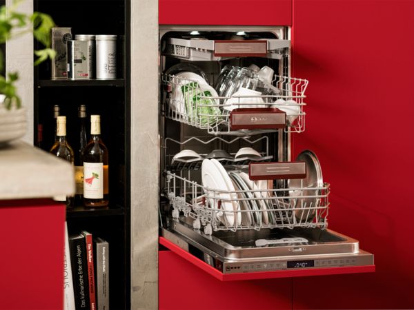 A modern dishwasher integrated into a wooden cabinet, accompanied by a sleek sink in a contemporary kitchen setting.