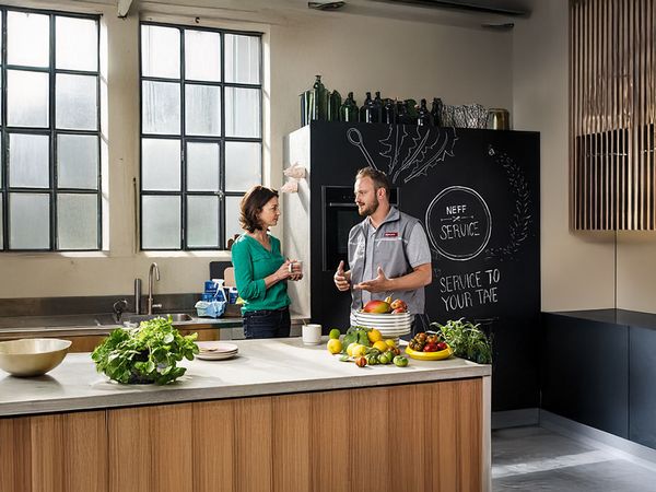 A customer and service technician talking to each other