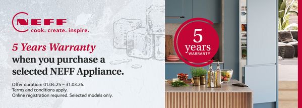 A modern kitchen with a sleek countertop, wooden cutting board, utensils, and a "5 years warranty" logo.