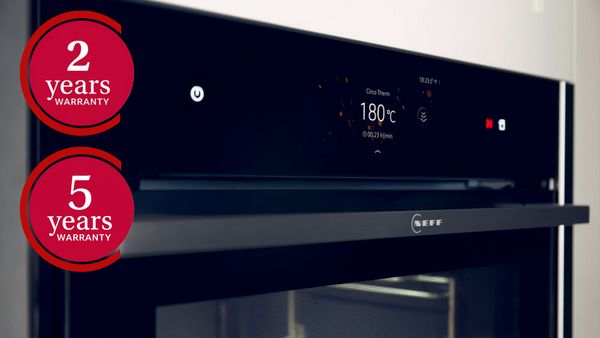  A black oven displaying a tag marked "5 years" and "2 years" signifying its five years or two years of warranty.