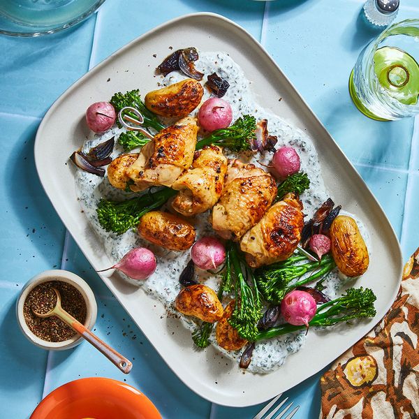 Lemon garlic chicken surrounded by vegetables on serving plate