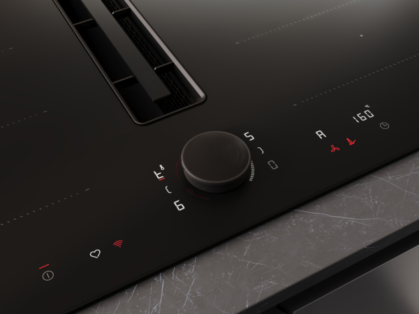 Detailansicht des Twist Pad Flex® auf einem NEFF Matt Black Kochfeld mit sichtbarer Temperatur- und Lüfteranzeige im Bedienfeld.