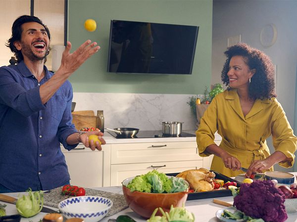 People playing with food cooking in kitchen