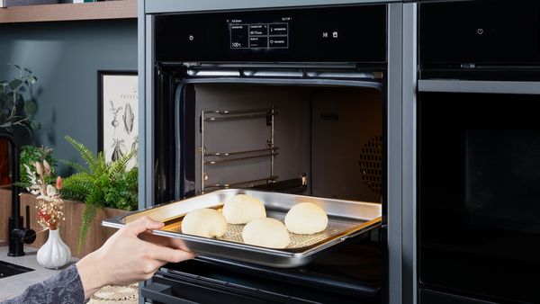 Preheat the oven to 100°C on Full Steam. Transfer the dumplings to a tray and place in the oven, let steam for approx. 15 min. Melt remaining butter in a small pot and set aside. Combine confectioner’s sugar and poppy seeds in a small bowl. Serve dumplings with vanilla sauce and some melted butter. Sprinkle with poppy seed and sugar mixture and garnish with fresh mint. Enjoy!
