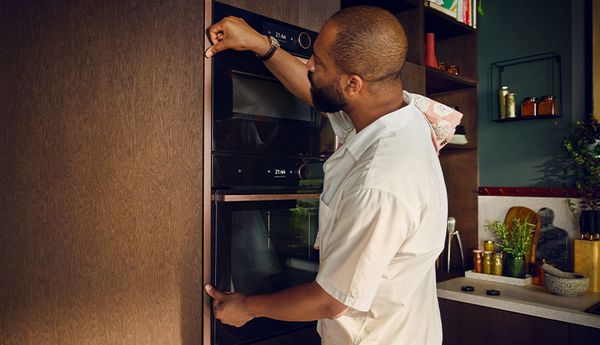 Person fitting coloured NEFF oven trim