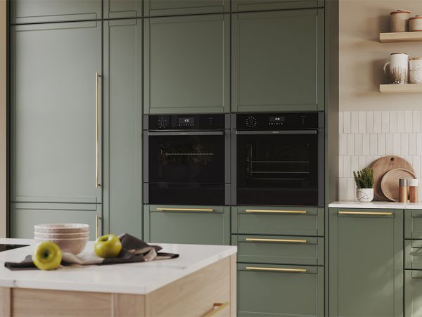 Side by side built in appliances in sage green cabinets