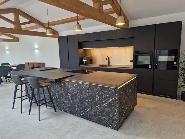 Side by side built in appliances in minimalist dark kitchen