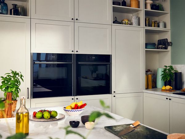 Side by side built in appliances in white kitchen cabinets