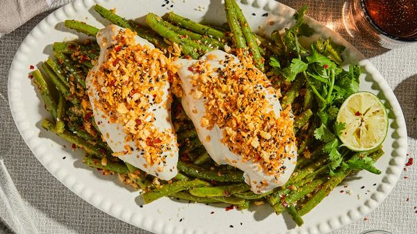 Steamed chicken breast with green beans served on a serving platter.
