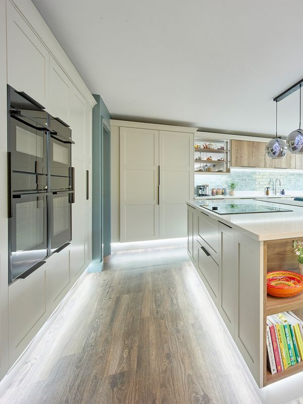 Stylish kitchen featuring a marble countertop, modern appliances, and a dining area. 