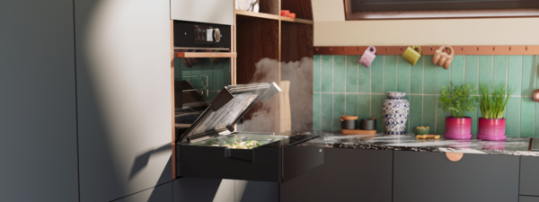 NEFF Dampfschublade in moderner Küche – platzsparend unter einem Backofen eingebaut, mit geöffnetem Glasdeckel und aufsteigendem Dampf beim Garen von frischem Gemüse.
