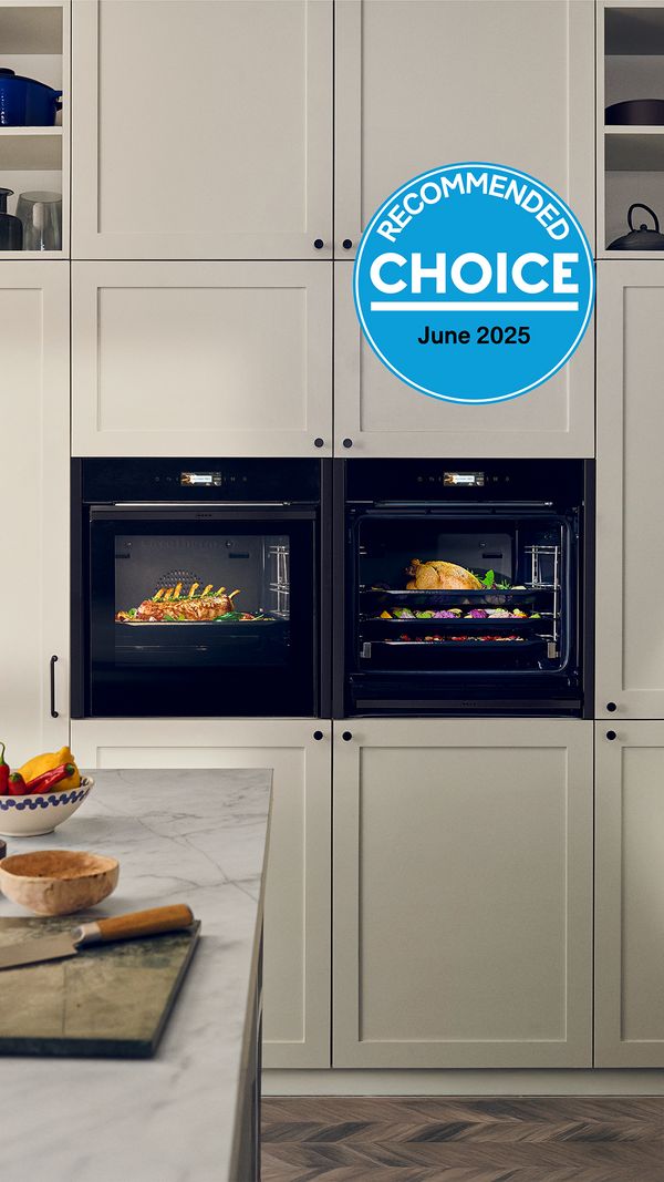 Two NEFF ovens in a kitchen with food cooking 