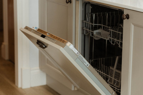 NEFF built in dishwasher with cupboard door open showing interior