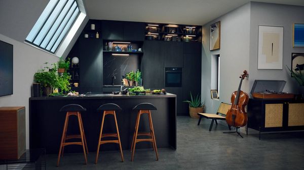 Deep black kitchen aesthetic with cello and record player in the corner