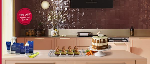 Modern kitchen with light pink cabinetry, a cooking area, and a promotional banner for 20% off accessories and care. 