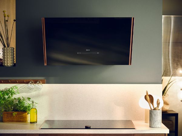 Colorful kitchen with chalkboard menu, cooking utensils, and various food items on shelves.