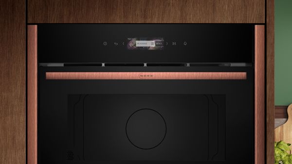 Primo piano del pannello di controllo touch di un forno da incasso NEFF con display digitale e manopola centrale