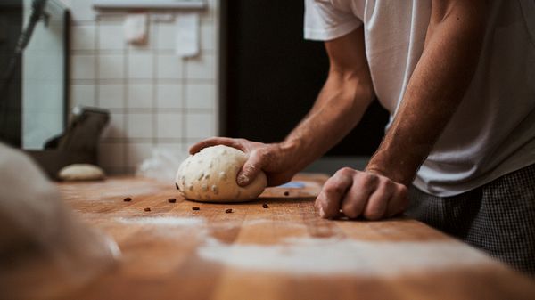 Person rolling bread dough